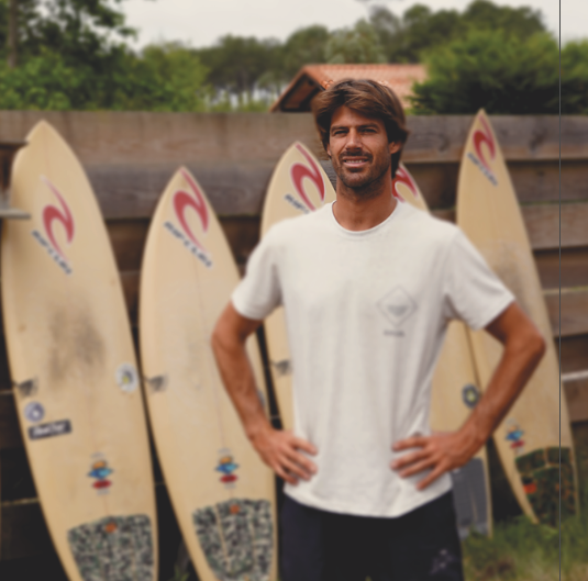Polyola ambassador Vincent Duvignac stands in front of his Polyola Surfboard quiver