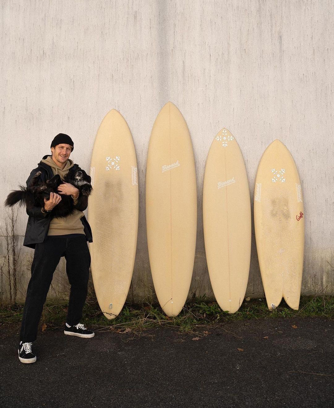 Polyola ambassador Boris Romann stands in front of his Polyola Surfboard quiver