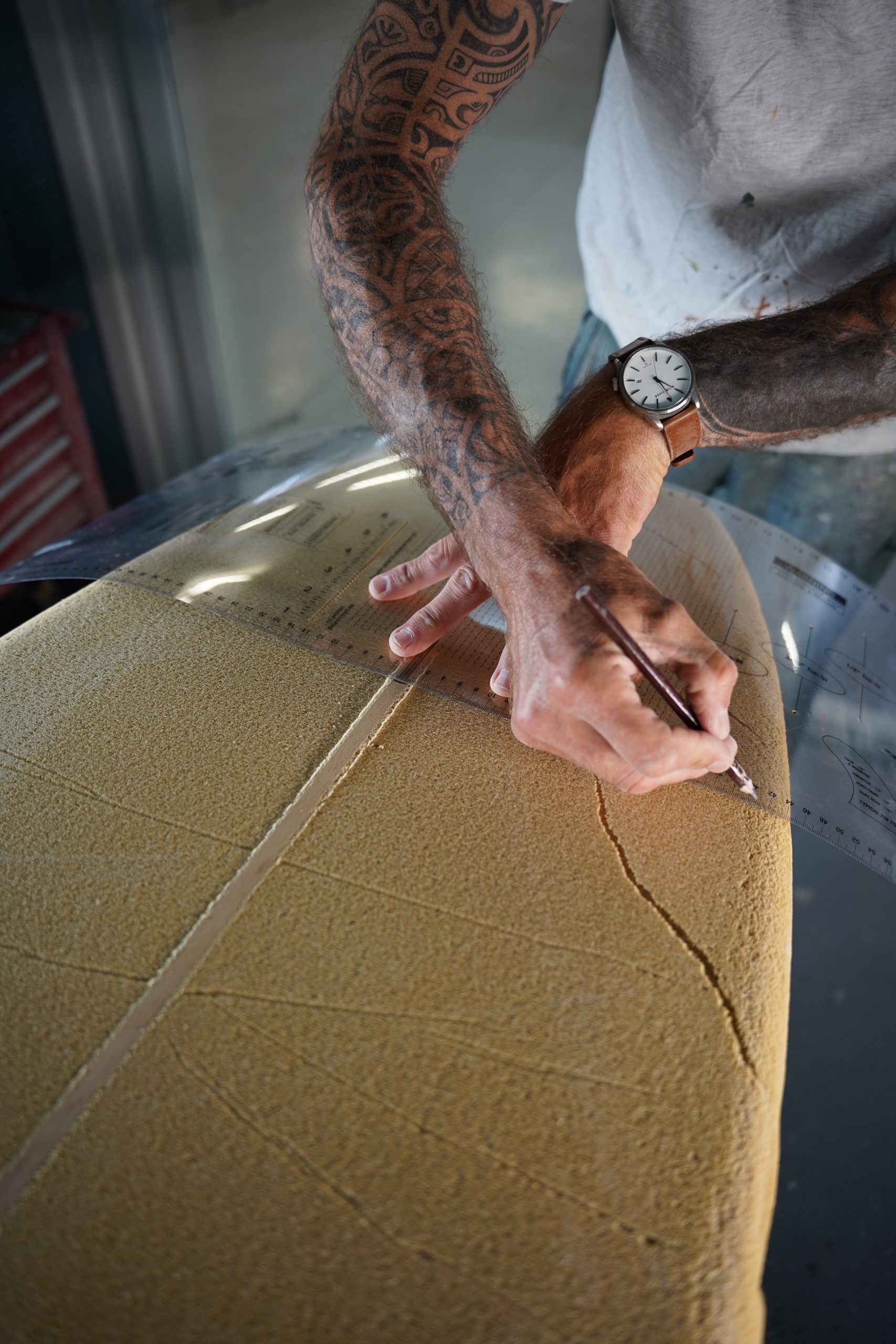 Shaper sets a mark at 1FT (approximately 30.5cm) from the nose and tail to shape a surfboard with Polyola Foam